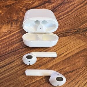 Apple AirPods, 1st Generation. Minimum wear, out of the box with charging cable.